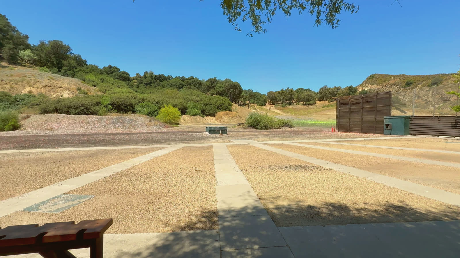 The skeet field: the concrete stations in a half circle, the high house at the far side.